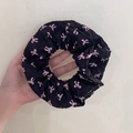 Hand holding a black double-layered lace scrunchie with pink bow patterns - Q616-4 Black Pink Bow Double