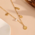 Detailed shot of golden sea-themed necklace with shell, seahorse and pearl charms - Shell Beach Necklace (T701)