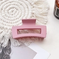Detail of a matte pink rectangular hair claw clip on a white woven coaster background - Medium Matte Square Claw-Korean Pink