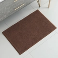 Absorbent brown chenille bathroom mat with non-slip texture on a grey tiled floor - Coffee