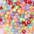 Macro detail of multi-colored acrylic beads with white star patterns for DIY jewelry making - 4x7mm Transparent Colored Star (100pcs)