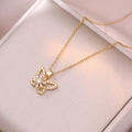 Detailed close-up of a butterfly pendant necklace with micro-pave cubic zirconia stones - Rotating Butterfly Necklace (X1041) / Gold