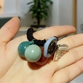 Detail of elastic hair tie with colorful beads, blue disc, and triangle pearl pendant - Black
