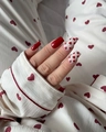 Short red glossy press-on nails with cream heart patterns shown on a real hand - BZ1648 Glossy Red Heart / Glue Type