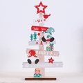 Close-up of wooden Christmas tree decor with festive figurines and holiday greetings - Sitting Gnome Style