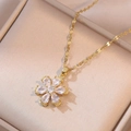 Macro detail of golden flower pendant with white cubic zirconia and wave chain - X0168 White Flower