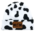 Detail of cow print knitted beanie with vintage brown leather MOM patch and calf icon - Dalmatian White/Black White Cow