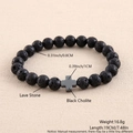 Detail view of 8mm black lava stone beads and black cholite cross pendant on stretch bracelet - Lava Stone Black Cholite Cross 19cm