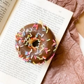 Phone grip socket with chocolate donut 3D design and colorful sprinkles on open book - Donut Holder-Brown