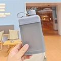Sleek gray flat square water bottle with portable loop held in a hand - 450ml / Gray