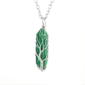 Macro view of green malachite hexagonal pendant with silver tree of life wire wrapping - Malachite