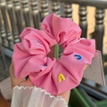 Detail of pink twill fabric scrunchie with colorful embroidered letters held by hand - Rose Pink Letter Fabric Scrunchie