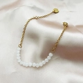 Minimalist gold chain bracelet featuring white translucent faceted beads and silk background - White