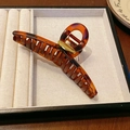Detail of amber tortoiseshell hair claw clip with golden handmade metal decoration - Tortoiseshell (Cross)