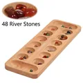 Close-up of wooden Mancala board set with 48 colorful natural rain flower stone pieces - Rubber Wood Mancala (Pebble Stones)