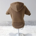 Brown pet hoodie with small pocket and ribbed cuffs shown on a white display rack - Tan