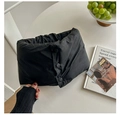 Close-up of black quilted down neck warmer featuring three round snap buttons for adjustment - Black