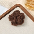 Macro detail of a 7cm brown crochet 3D flower accessory on a rustic wooden tray - 7cm / Mohair Coffee
