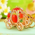 Close-up of golden pumpkin carriage keychain with colorful rhinestones and sparkling gems - Cinderella Pumpkin Carriage Orange