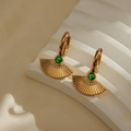 Gold plated fan-shaped earrings featuring green emerald-like center stones on white fabric - Green Gemstone Fan
