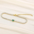 Elegant gold titanium bracelet featuring sparkling zircons and a green heart glass gem - Gold Green Stone (KB168990-Z)