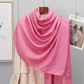 Detail showing soft pink linen scarf texture paired with a beige coat for a stylish layer - Dusky Pink