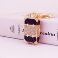 Golden rhinestone luggage-shaped keychain with black trim and sparkling crystals accessory - Black