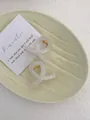 Detail of elegant cream and pink twist hair claws in a ceramic dish setup - Mini Butterfly Clip X-Shaped (Approx. 4cm) / Jelly White