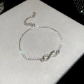 Detail of silver infinity bracelet with zircon stones and adjustable slider clasp - Silver