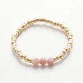 Detail of handmade gold beaded ring with three faceted pink natural stone accents - Gold Pink