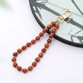 Detail of red gold sandstone beads with gold metal spacers and lobster clasp phone charm - K3421 Gold Sandstone Natural Stone Pendant