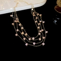 Detail of layered gold necklace with sparkling pink zircon crystals on a dark surface - Pink Zirconia Multi-layer Necklace