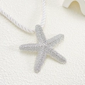 Macro shot of silver starfish pendant with white pavé zircons on woven rope necklace - Silver Rhinestone Starfish Necklace (N-506)