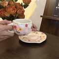 Detailed view of hand-painted floral ceramic coffee cup set with matching saucer - Pink Floral