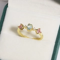 Detailed close-up of a golden flower ring with light blue oval stone and pink gems - Light Blue Oval Main Stone Three-Stone Setting Style (金色16)