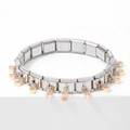 Silver stainless steel bracelet with golden charms and pink gemstones on white block - Fresh Pink