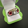 Detailed close-up of retro owl ring with red gemstone eyes inside a green jewelry box - Multicolor Red