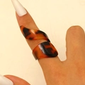 Macro shot of tortoiseshell resin ring with brown spiral geometric pattern on hand - Spiral Wrap Style / Amber (4875)
