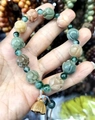 Close-up of colorful lotus-shaped agate beads and wooden lotus pod charm on a bracelet - Lotus Carved Bracelet