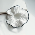 White double-layered lace hair scrunchie with navy blue edges on a book background - Q455 White Black Piping