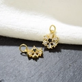 Macro detail of gold snowflake pendants with cubic zirconia for DIY jewelry making - Black