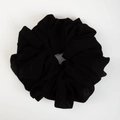 Close-up of a premium black elastic chiffon scrunchie with soft fabric pleats texture - Jet Black