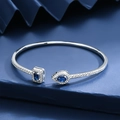 Luxury adjustable open bangle with pear and square blue gemstones in silver setting - Blue