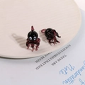 Macro detail of a 3D glass octopus spider pendant in translucent dark purple and black - Deep purple