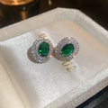 Macro shot of oval green gemstone earrings with sparkling halo zircon setting in white box - Oval Halo Style (6#)
