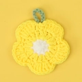 Handmade crochet sunflower dishcloth with yellow petals and white center on yellow backdrop - Yellow Crochet Flower
