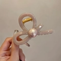 Detail of twisted cream resin hair claw clip with elegant pearl accent and gold spring - Taro Purple (Pink Pearl)