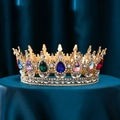 Luxurious gold crown with multi-colored crystals and teardrop gemstones on blue silk - Gold Base Rainbow Rhinestone
