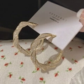 Elegant gold twisted hoop earrings with shimmering inlay on white jewelry card - E5298 Gold Twisted Rope Hoop