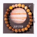 Detailed macro shot of solar system beads on a Jupiter card with tiger eye and wood - Jupiter (With Card)